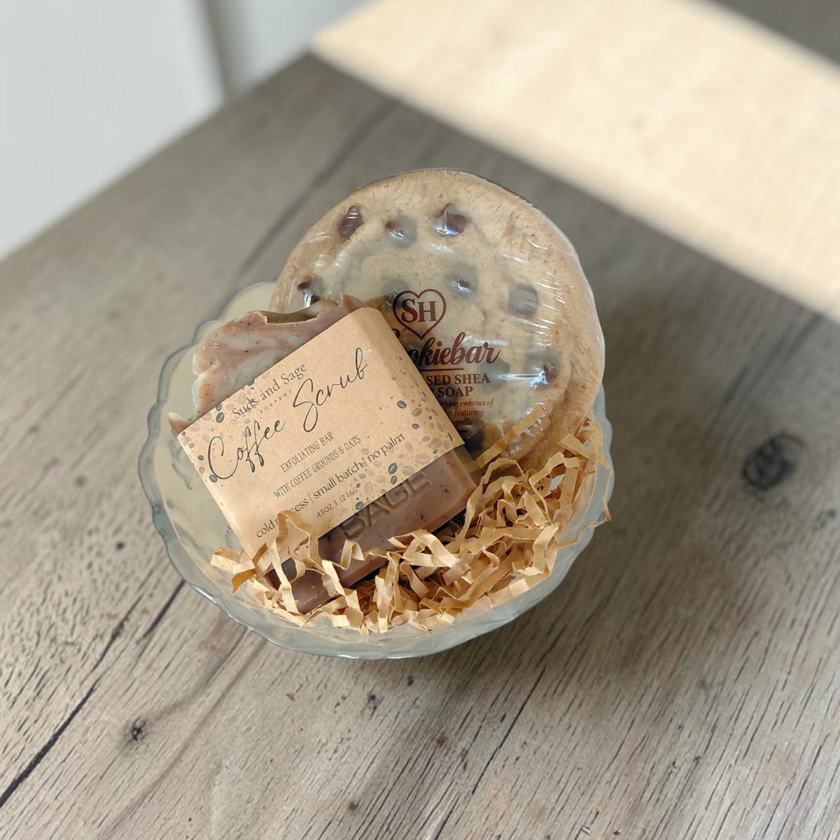 Vintage rose glass bowl filled with Coffee Scrub and Chocolate Chip Cookie Bar artisan soaps, styled as a thoughtful gift set.