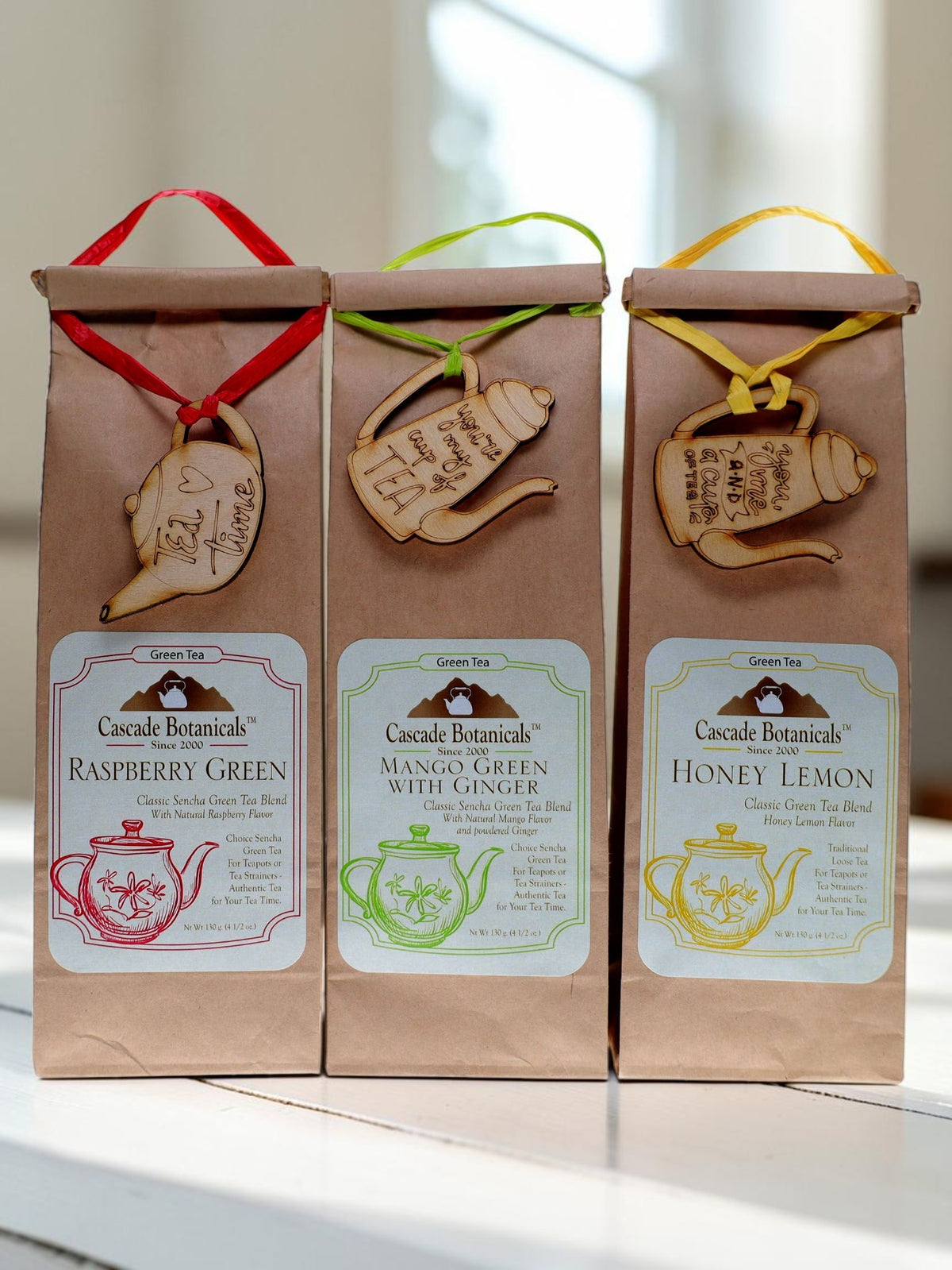 Green loose leaf tea in kraft bags with a tea charm
